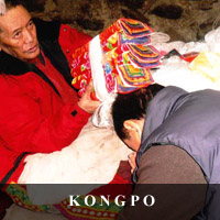 photo of the great Yogi Thogden Yungkar Rinpoche blessing Tashi Jamyangling with  Rinpoche's holy texts in Rinpoche's retreat hut