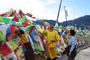 Genyen Jamyangling and Loga Rinpoche hoisting Dugkar flags in the foothills of Kawakarpo.