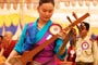 Tenpela Jamyangling playing dramyen (Tibetan guitar) for the Inauguration.