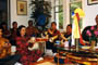 A Prosperity Vase ceremony being conducted in Tana Pesso's home in Cambridge, Massachusetts.  Seated in the center are Tana and her son, Chris holding a prosperity vase in their hands.